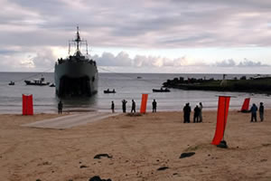 The crane is standing by on the beach in the bay of Anakena for further transport to the destination